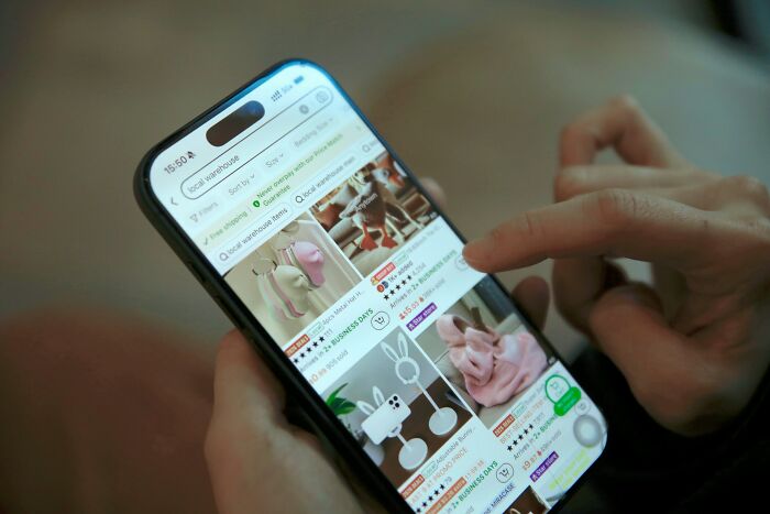 Person browsing online store products on smartphone, one of the companies people refuse to buy from.