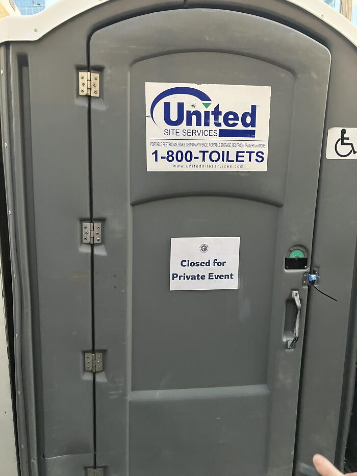 A portable toilet with a paper sign reading closed for private event among absurd signs.