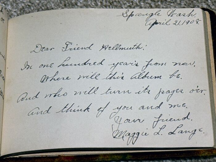 Old vintage journal page with handwritten cursive message dated 1908, showing historical found paper.