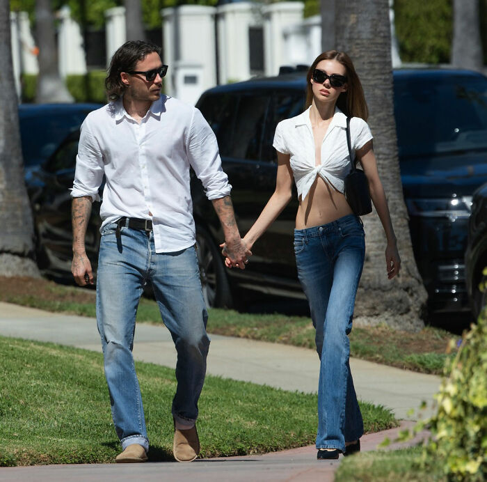 Nicola and Brooklyn Beckham holding hands walking outdoors Nicola and Brooklyn Beckham holding hands walking outdoors
