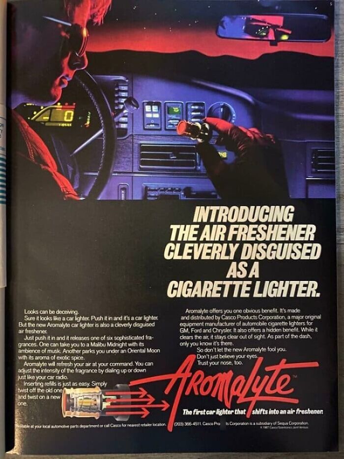 Retro air freshener disguised as a cigarette lighter inside a car dashboard at night