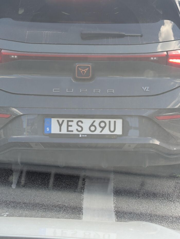 Close-up of a Cupra car rear featuring an absurd license plate reading YES 69U.