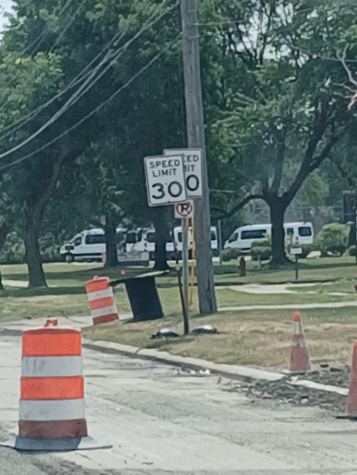 Absurd signs showing a road sign misaligned to read a speed limit of 300.