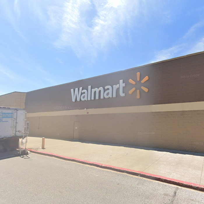 Exterior view of a Walmart building with the brand logo under a clear blue sky Exterior view of a Walmart building with the brand logo under a clear blue sky