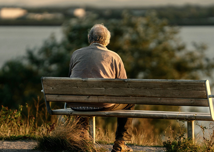 Elderly man sitting on a park bench, representing Lewy Body Dementia symptoms in seniors. Elderly man sitting on a park bench, representing Lewy Body Dementia symptoms in seniors.