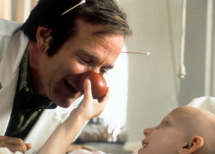 Robin Williams in Patch Adams wearing a red clown nose, highlighting his career before Lewy body dementia. Robin Williams in Patch Adams wearing a red clown nose, highlighting his career before Lewy body dementia.