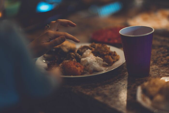 Plate of comfort food and dark drink cup representing weight-related comments