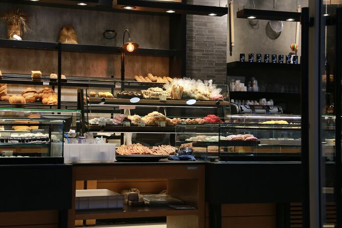 Bakery display full of breads and pastries with warm lighting