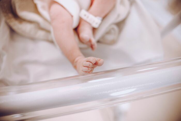 Close up of a newborn baby's feet in a hospital highlighting human body facts