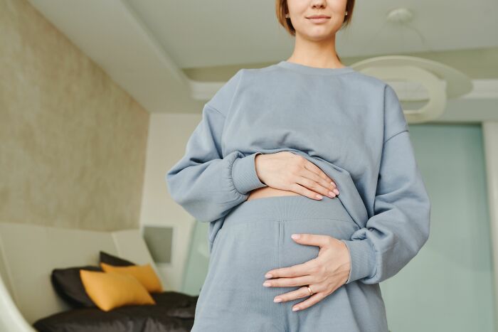 A pregnant woman holding her belly showing human body facts