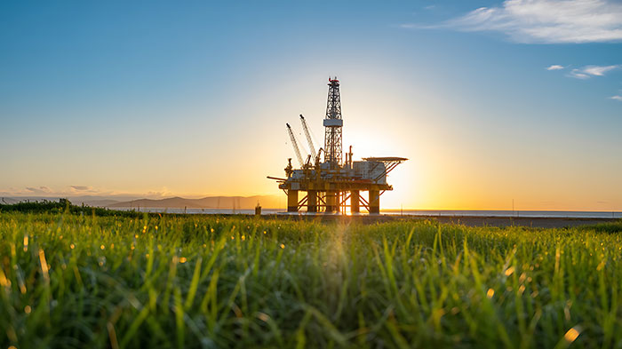 Offshore oil rig at sunset symbolizing hazardous oil industry jobs