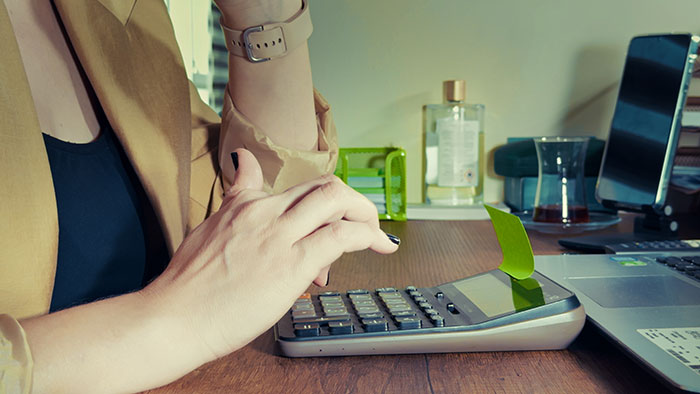 Person calculating finances in stressful office job