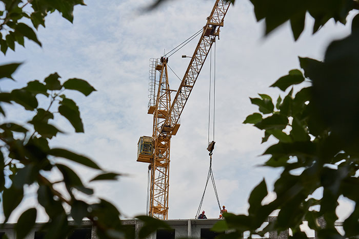 Construction site crane lifting materials hazard job