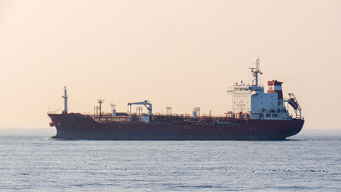 Large oil tanker ship sailing on open sea waters