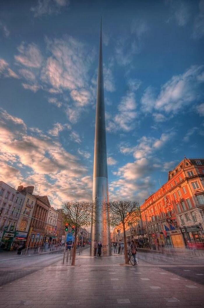 The Spire monument in Dublin, Ireland, a towering example of public art rising into a cloudy blue sky.