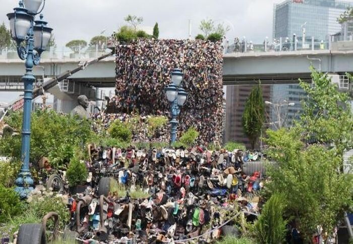 A bizarre public art installation made of thousands of shoes stacked high in an urban outdoor setting