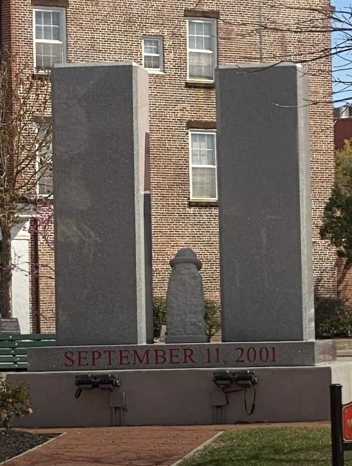A minimalist public art monument depicting the World Trade Center towers with September 11, 2001 inscribed.