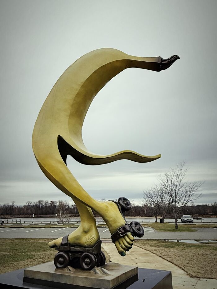 A bizarre public art sculpture of a banana wearing roller skates