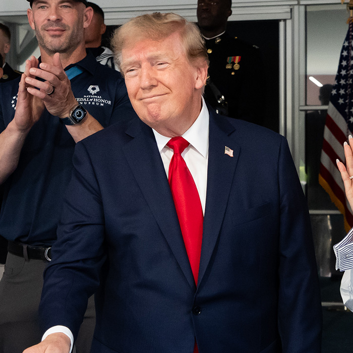 Donald Trump in suit with red tie at public event Donald Trump in suit with red tie at public event
