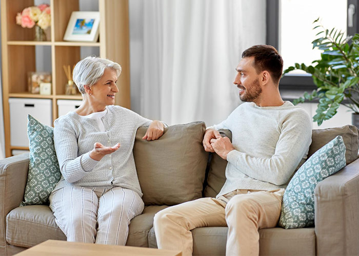 A man sitting on a sofa talking with his mother, illustrating a fiance's 3-year lie revealed A man sitting on a sofa talking with his mother, illustrating a fiance's 3-year lie revealed