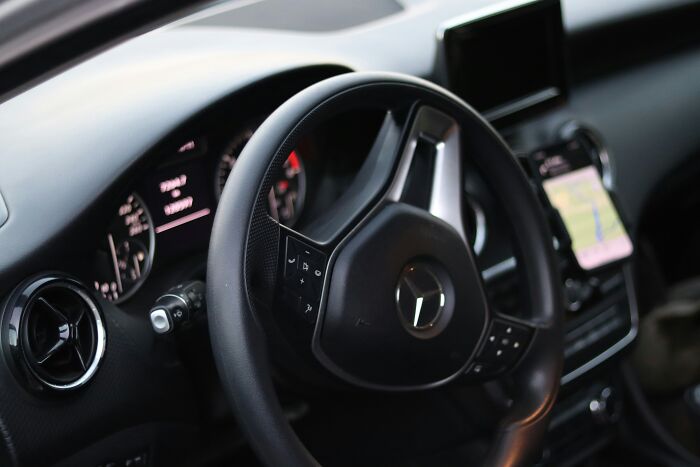 Close up of a car steering wheel, showing how one wrong move while driving can lead to everything falling apart.