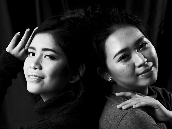 Two women posing back to back in a black and white portrait for hilarious BF phone discoveries