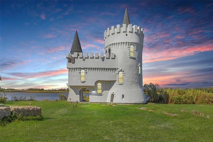 White castle-like strange building with turrets at sunset