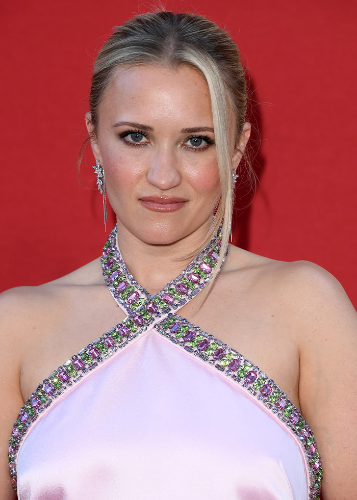 Close-up portrait of Young Sheldon star Emily Osment wearing a embellished halter neck dress at an event Close-up portrait of Young Sheldon star Emily Osment wearing a embellished halter neck dress at an event