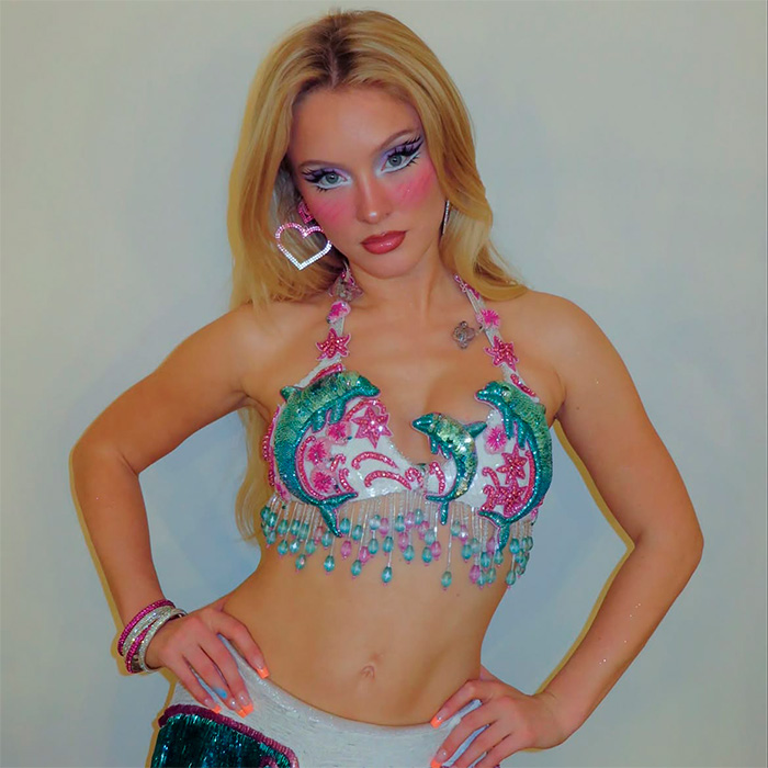Zara Larsson posing in a blue and pink beaded dolphin crop top and mermaid-style makeup Zara Larsson posing in a blue and pink beaded dolphin crop top and mermaid-style makeup