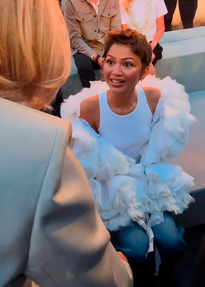 Zendaya looks surprised while greeting France's First Lady during Paris Fashion Week. Zendaya looks surprised while greeting France's First Lady during Paris Fashion Week.