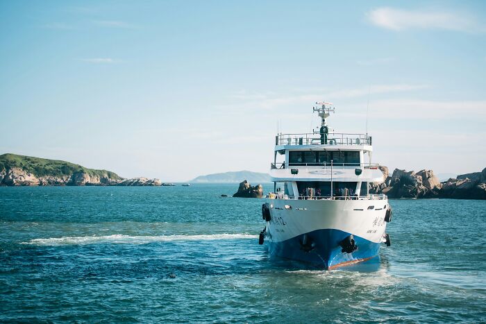 Large ferry sailing on open waters, setting the scene for dramatic infidelity stories.