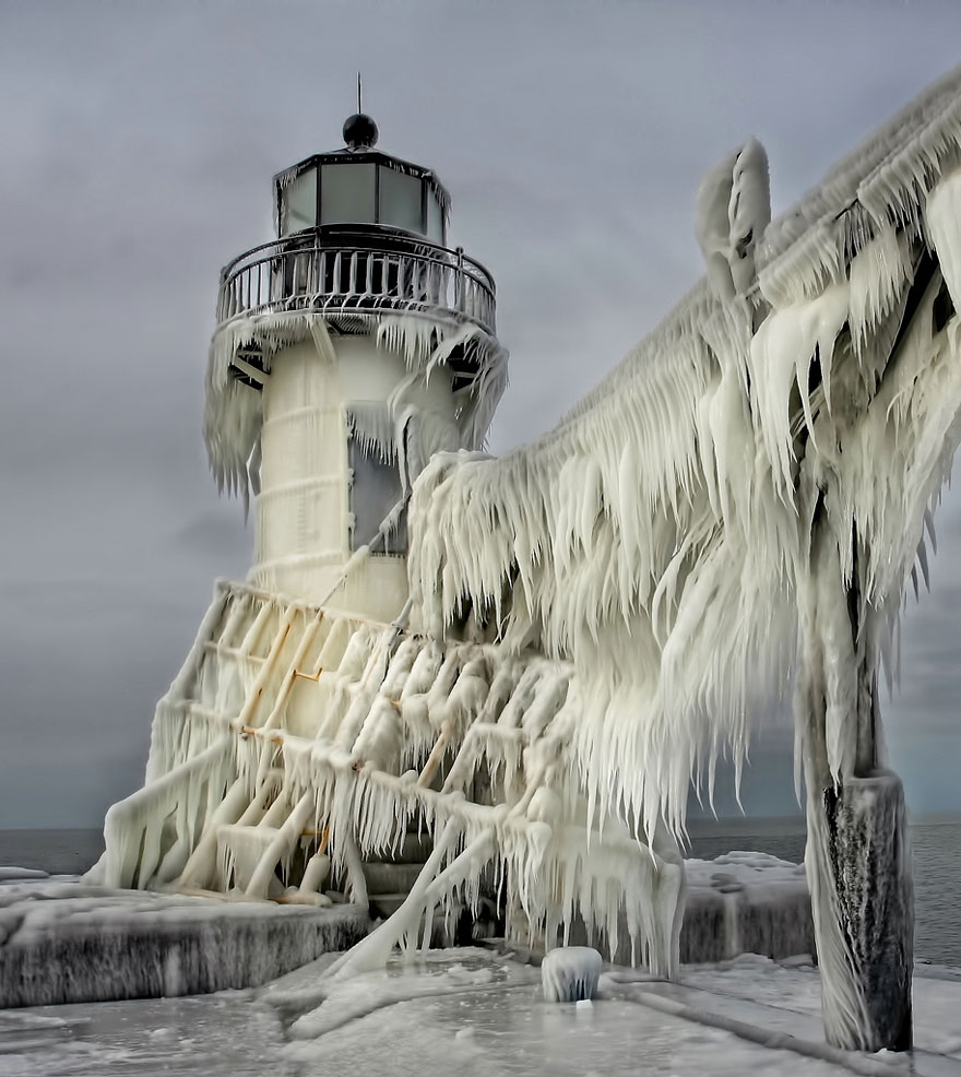 Frozen Lighthouses Caught In Winter's Icy Grip On Lake Michigan Shore