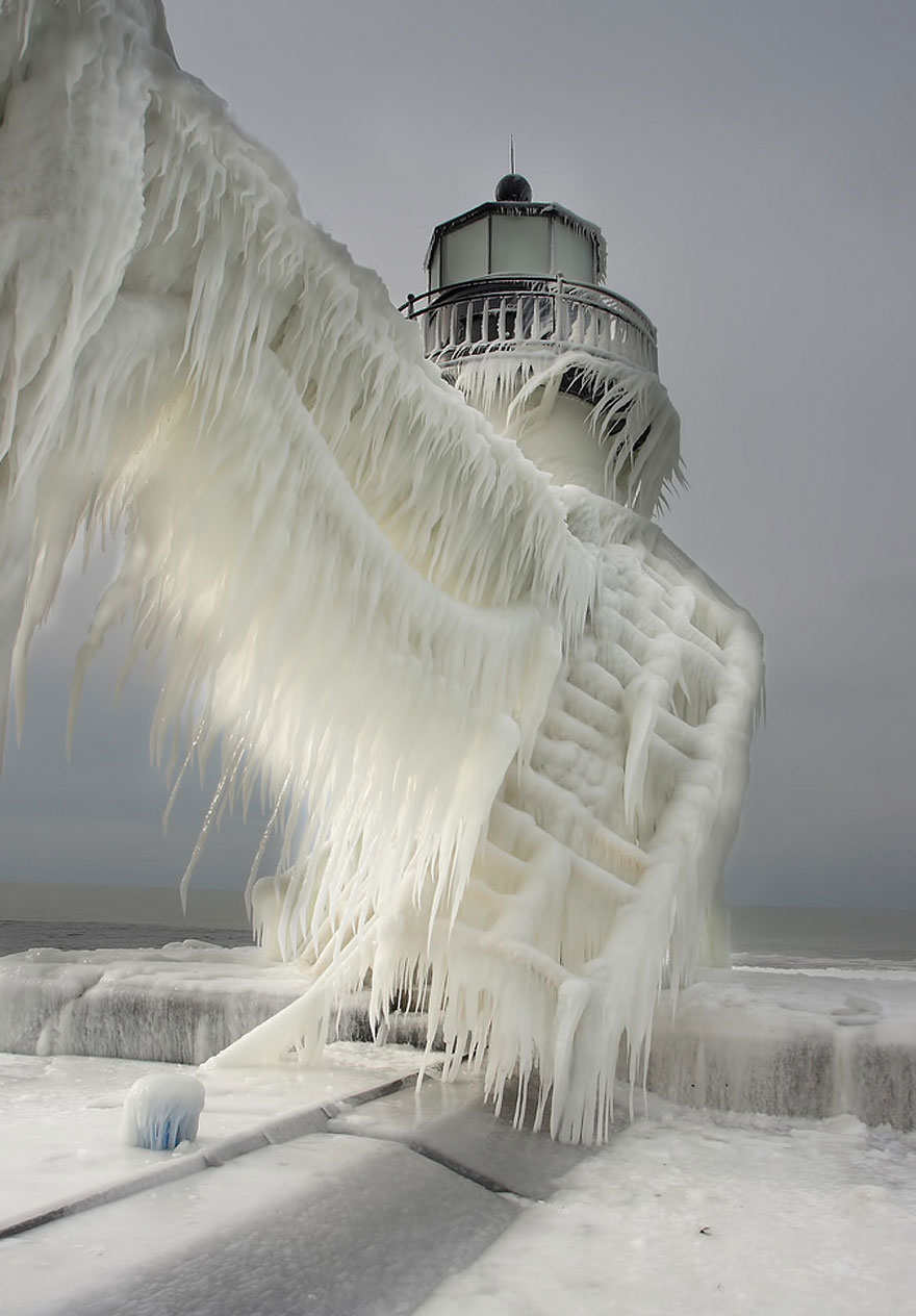 Frozen Lighthouses Caught In Winter's Icy Grip On Lake Michigan Shore